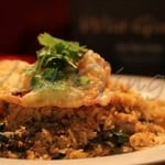 traditional thai fried rice with egg, broccoli, onion & basil topped with another fried egg with soy sauce.