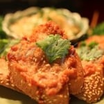 deep fried mixture of minced prawns & chicken thick spread on crispy bread, serve with sweet chilli sauce.