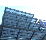 Natural anodised perforated aluminium sunshades on galvanized steel outriggers.