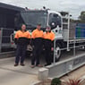 photo of 3 staff with truck on weightbridge