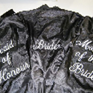 Embroidery on the back of satin robes for a bridal party