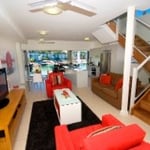 Beachside Townhouse - Internal photo of the Living, Dining, Kitchen and Balcony Areas with views to the Harbour