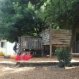 Children has naturally shaded outdoor play area with equipment and activities set up for fun and learning.